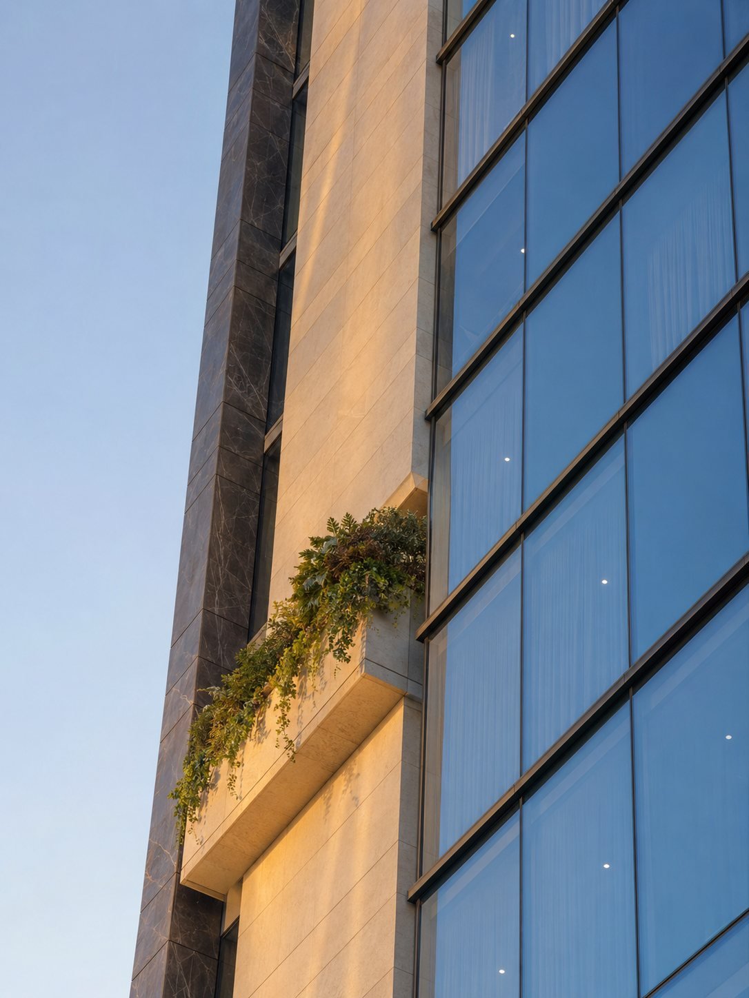 Concept render: facade detail of the Sunshine tower with a planted balcony in dawn light